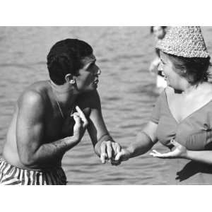 com Italian Man Talking to a Woman While Enjoying a Day at the Beach 